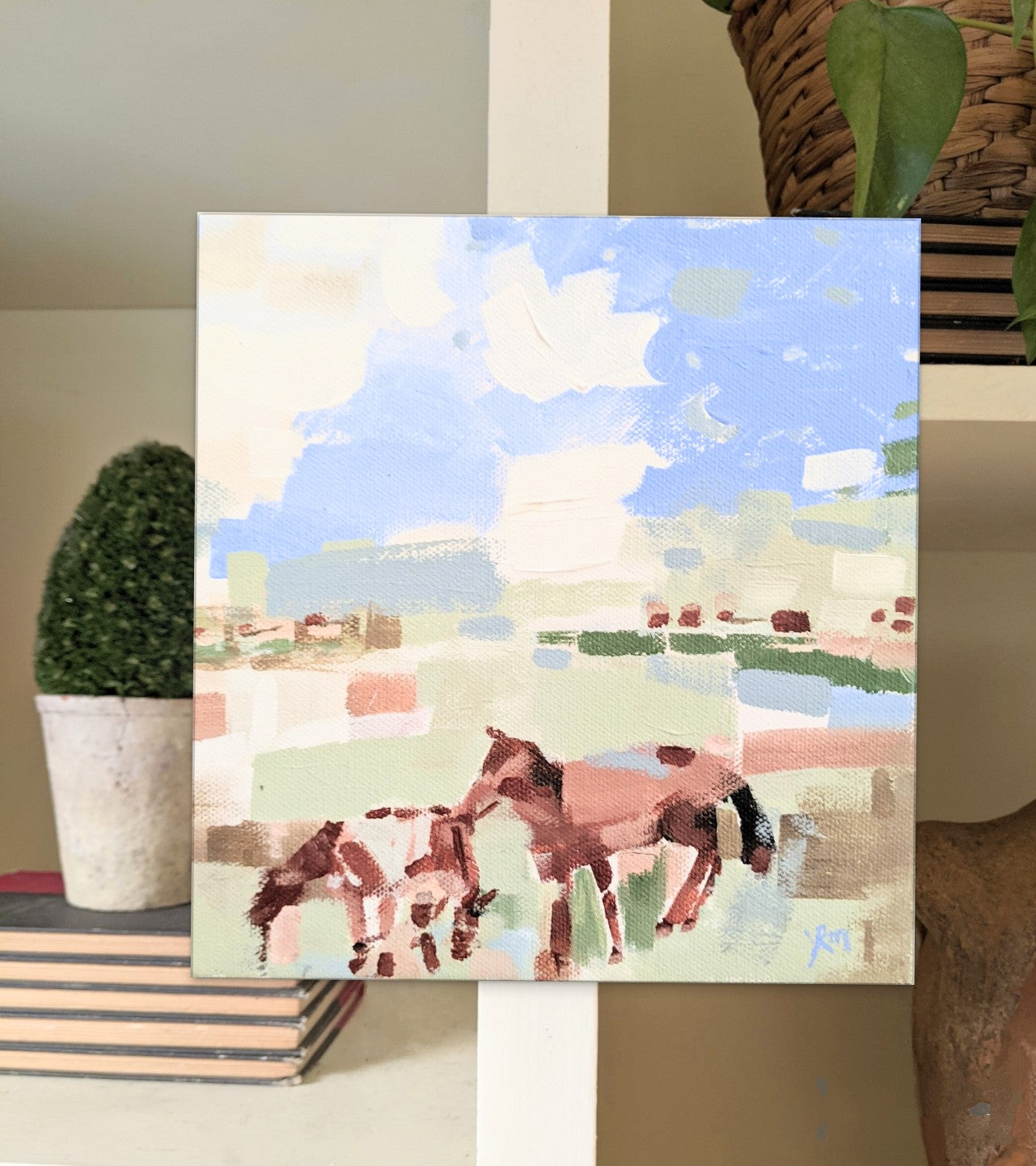 Farmhouse style horse lover painting on country house library shelves